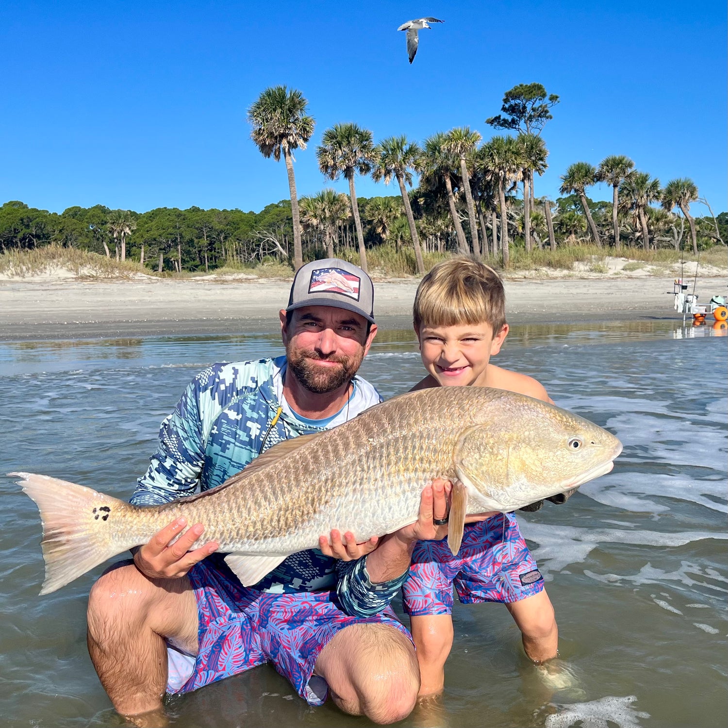 Captain Randy Klimek and his son with a redfish they landed and safely released while fishing together